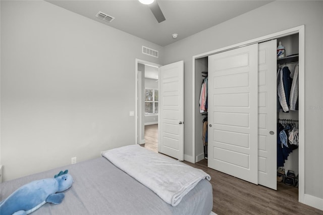 bedroom featuring ceiling fan, a closet, and dark wood-type flooring