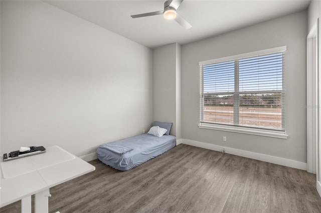 unfurnished bedroom with ceiling fan and hardwood / wood-style floors