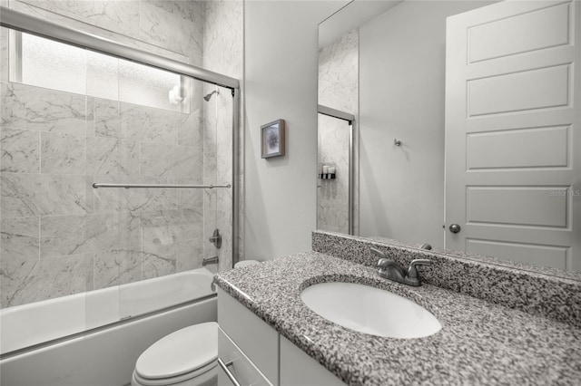 full bathroom with shower / bath combination with glass door, vanity, and toilet