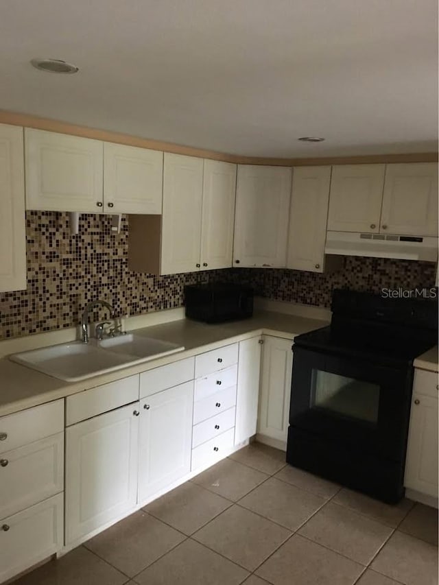 kitchen with white cabinets, sink, backsplash, black electric range, and light tile patterned floors