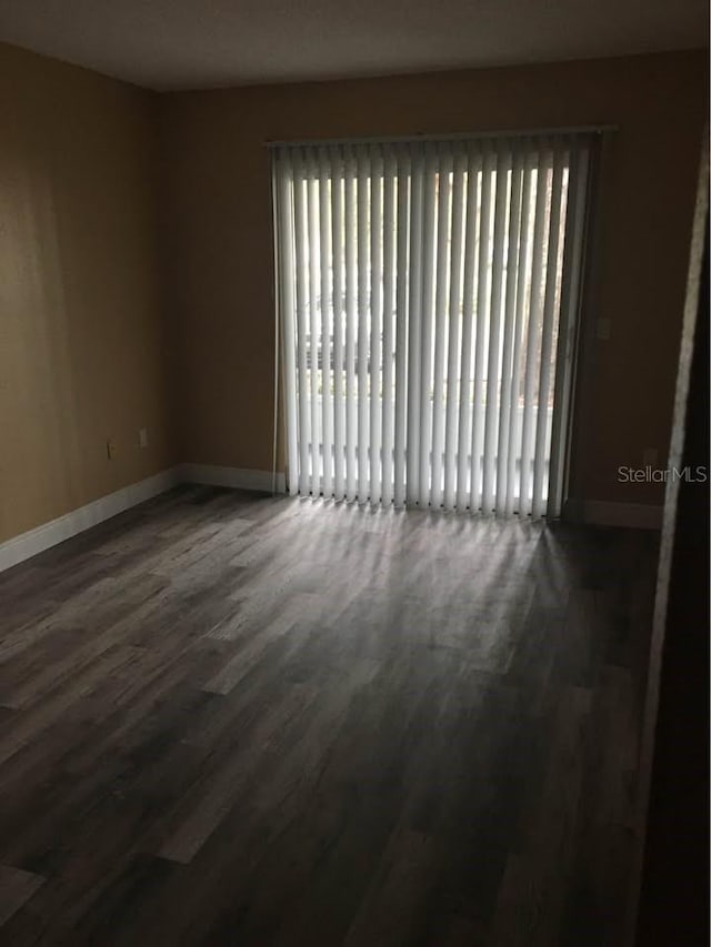 unfurnished room featuring dark hardwood / wood-style floors