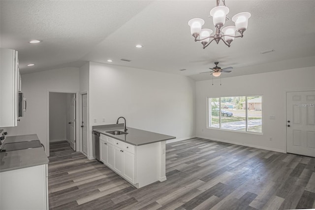 kitchen with a textured ceiling, white cabinets, appliances with stainless steel finishes, decorative light fixtures, and sink