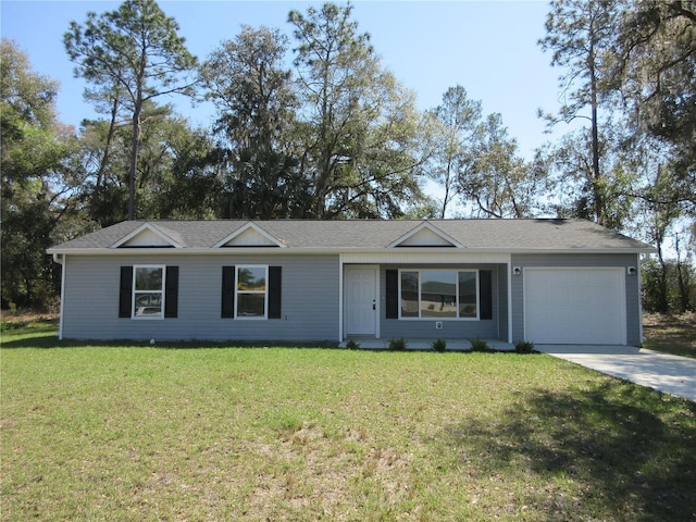 ranch-style house featuring driveway, an attached garage, and a front yard