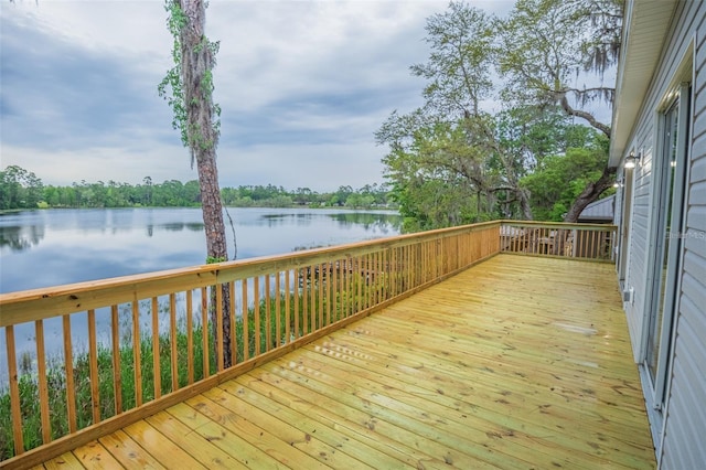 wooden terrace featuring a water view