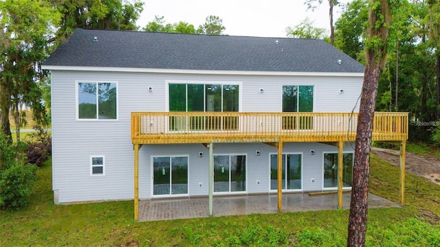 back of property featuring a lawn and a patio