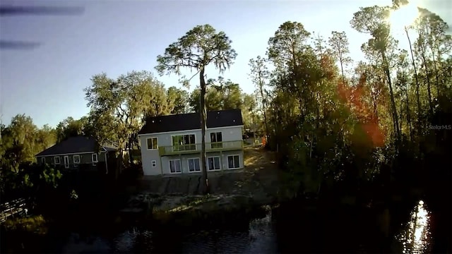 back of property featuring a water view