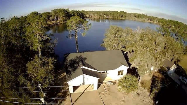 bird's eye view with a water view and a wooded view