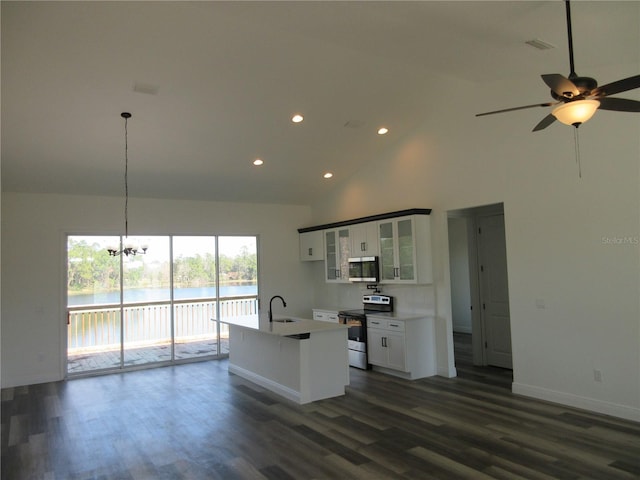 kitchen featuring white cabinets, glass insert cabinets, stainless steel appliances, pendant lighting, and a sink