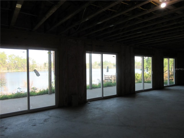 unfurnished room featuring a water view and a wealth of natural light