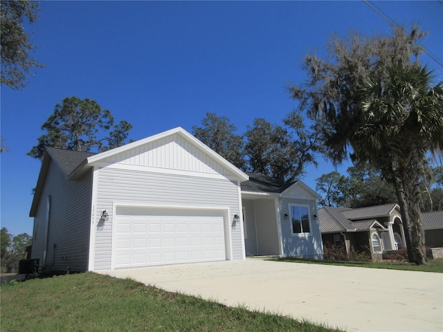 ranch-style house with a garage, driveway, and a front yard