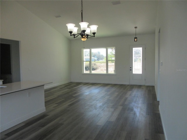 unfurnished living room with dark wood-style floors, visible vents, an inviting chandelier, vaulted ceiling, and baseboards