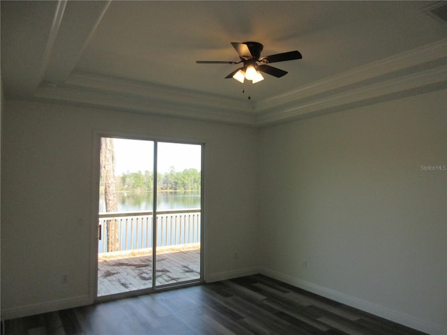 empty room with dark wood-style floors, a water view, ornamental molding, and baseboards