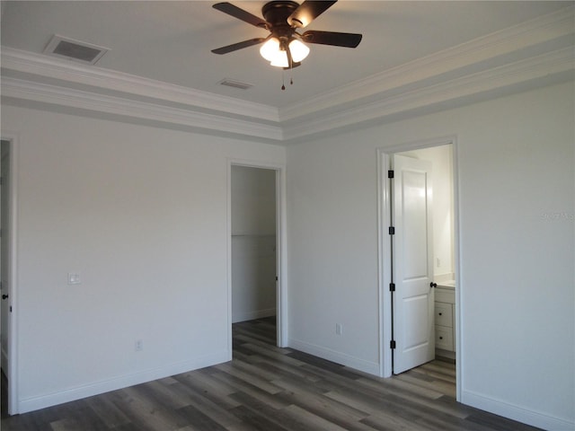 unfurnished bedroom with visible vents, dark wood finished floors, and ornamental molding