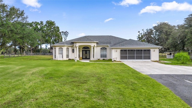 view of front facade with a front lawn and a garage