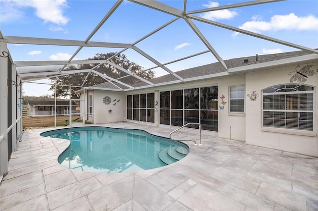 view of swimming pool with a lanai and a patio