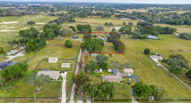 birds eye view of property with a rural view