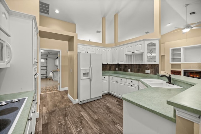 kitchen featuring ceiling fan, black electric cooktop, white fridge with ice dispenser, white cabinets, and sink