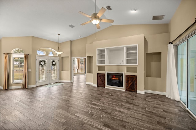 unfurnished living room featuring ceiling fan, high vaulted ceiling, built in features, and dark wood-type flooring