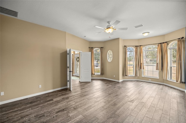 unfurnished room featuring ceiling fan and dark hardwood / wood-style floors