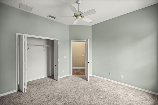 unfurnished bedroom with ceiling fan, light colored carpet, and a closet