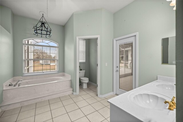 bathroom with toilet, vanity, a bathing tub, and tile patterned flooring