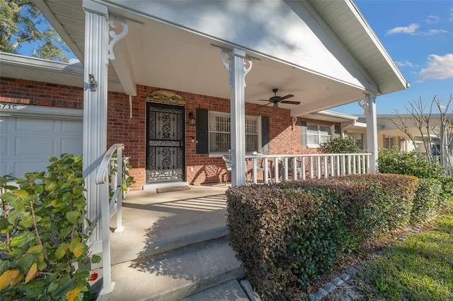 view of exterior entry with ceiling fan and covered porch