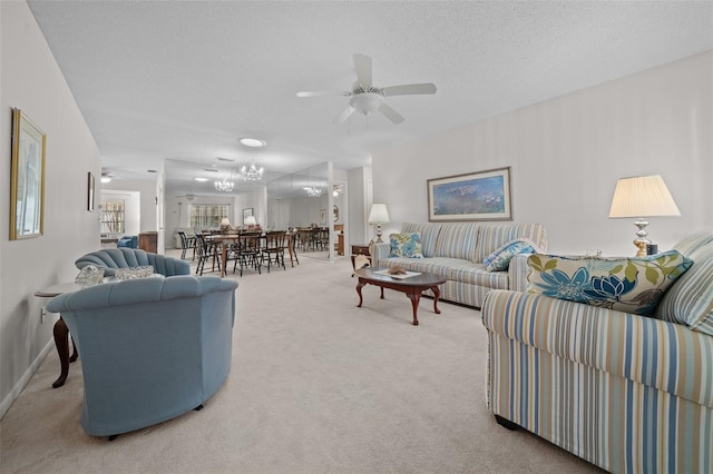 living room with ceiling fan, carpet floors, and a textured ceiling