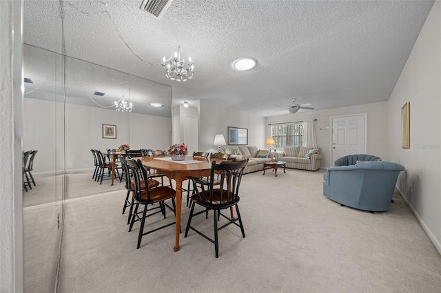 dining area featuring ceiling fan with notable chandelier, a textured ceiling, and carpet flooring