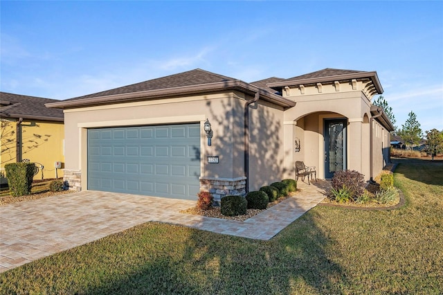 view of front of property with a front yard and a garage