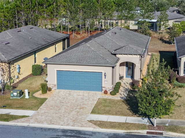 view of front of home featuring a front yard and a garage