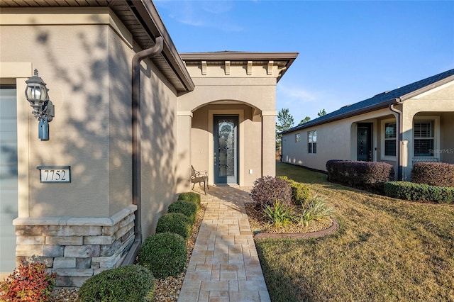 entrance to property with a yard