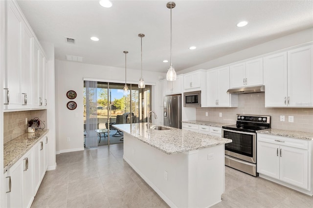 kitchen featuring white cabinets, an island with sink, and stainless steel appliances