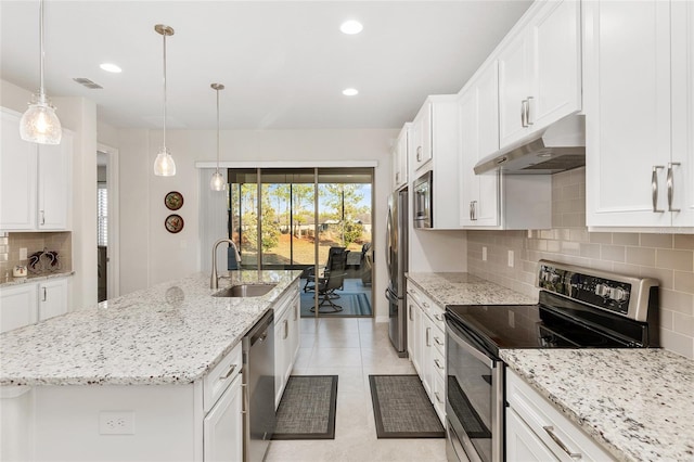 kitchen featuring white cabinets, appliances with stainless steel finishes, tasteful backsplash, sink, and a center island with sink