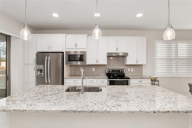 kitchen featuring tasteful backsplash, sink, hanging light fixtures, appliances with stainless steel finishes, and white cabinets