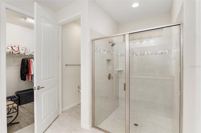 bathroom with a shower with door