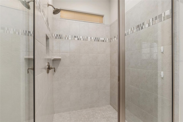 bathroom featuring a shower with shower door