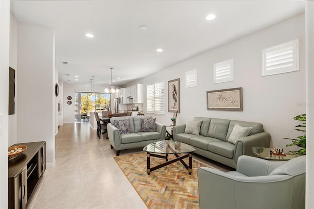 tiled living room with a chandelier