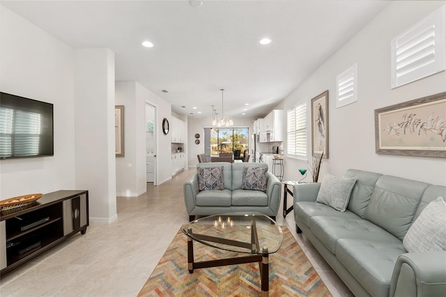 living room featuring light tile patterned floors and a notable chandelier