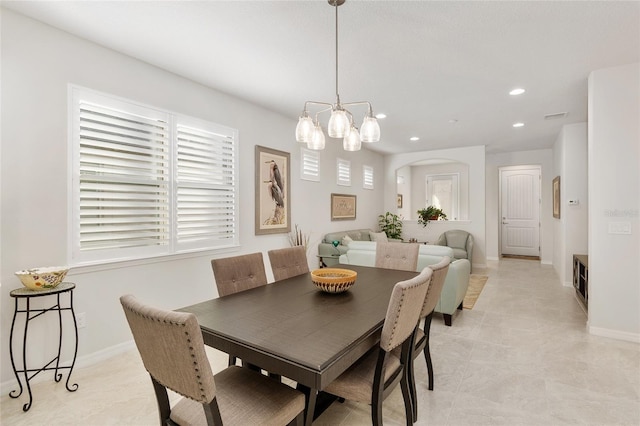 dining space with a wealth of natural light and an inviting chandelier