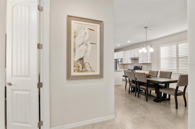 dining area featuring a notable chandelier