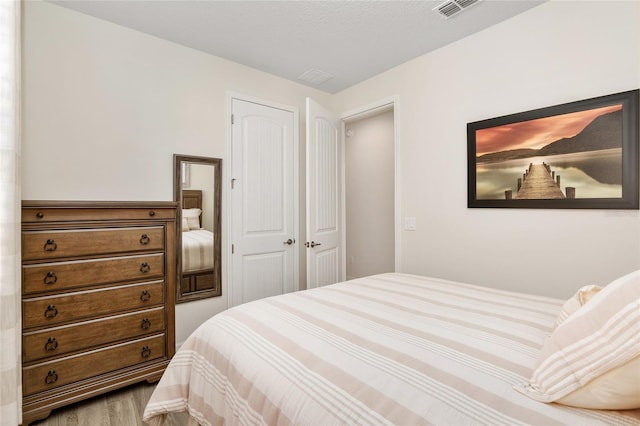 bedroom featuring a closet and hardwood / wood-style floors