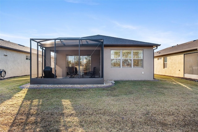 rear view of property featuring glass enclosure and a lawn