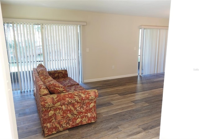 sitting room with dark wood-type flooring