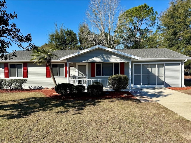 ranch-style home with a front lawn, covered porch, and a garage