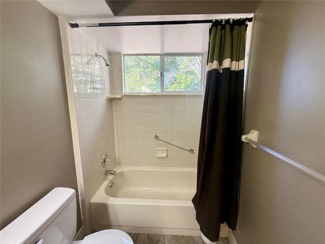 bathroom featuring toilet and shower / bath combo