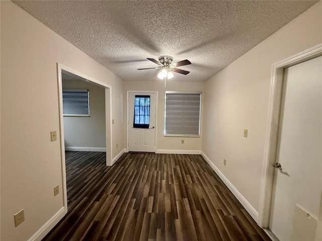 interior space with ceiling fan, dark hardwood / wood-style floors, and a textured ceiling