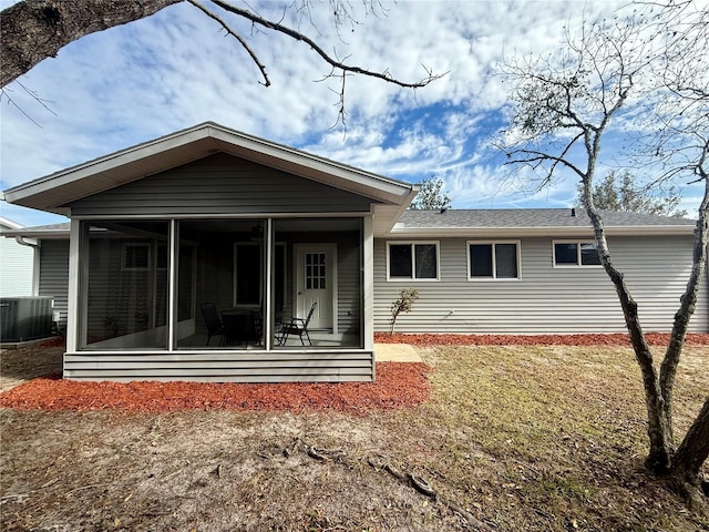 rear view of house with cooling unit and a sunroom