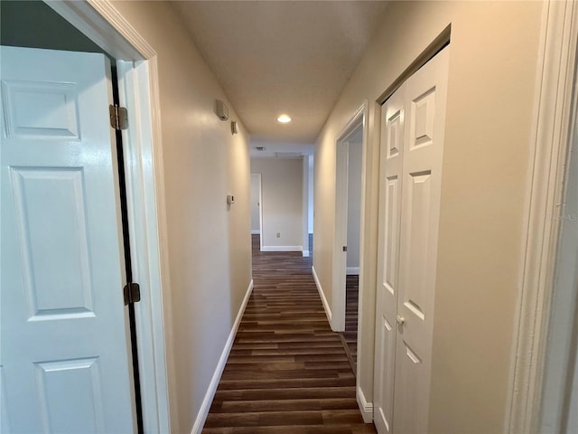 corridor with dark hardwood / wood-style floors