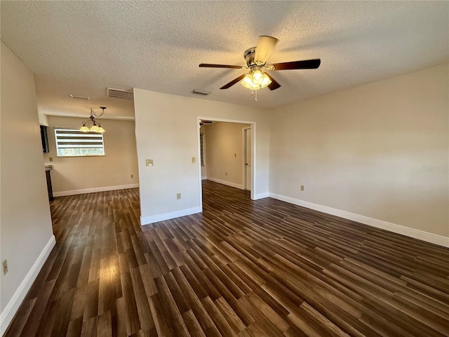 spare room featuring a textured ceiling, ceiling fan, and dark hardwood / wood-style flooring