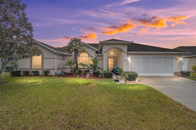 view of front of house featuring a lawn and a garage